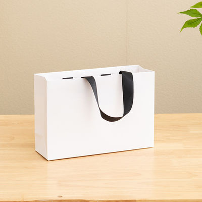 Bolsas de papel impressas personalizadas de papelão Bolsa de presente de papel Kraft branco de luxo para bolsas de compras